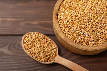 Green buckwheatin  on a wooden kitchen table.Superfood.Raw buckwheat porridge.Healthy vegan food concept, eco products, diet. Copy space.Organic food.weight loss and proper nutrition.