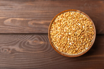 Green buckwheatin  on a wooden kitchen table.Superfood.Raw buckwheat porridge.Healthy vegan food concept, eco products, diet. Copy space.Organic food.weight loss and proper nutrition.