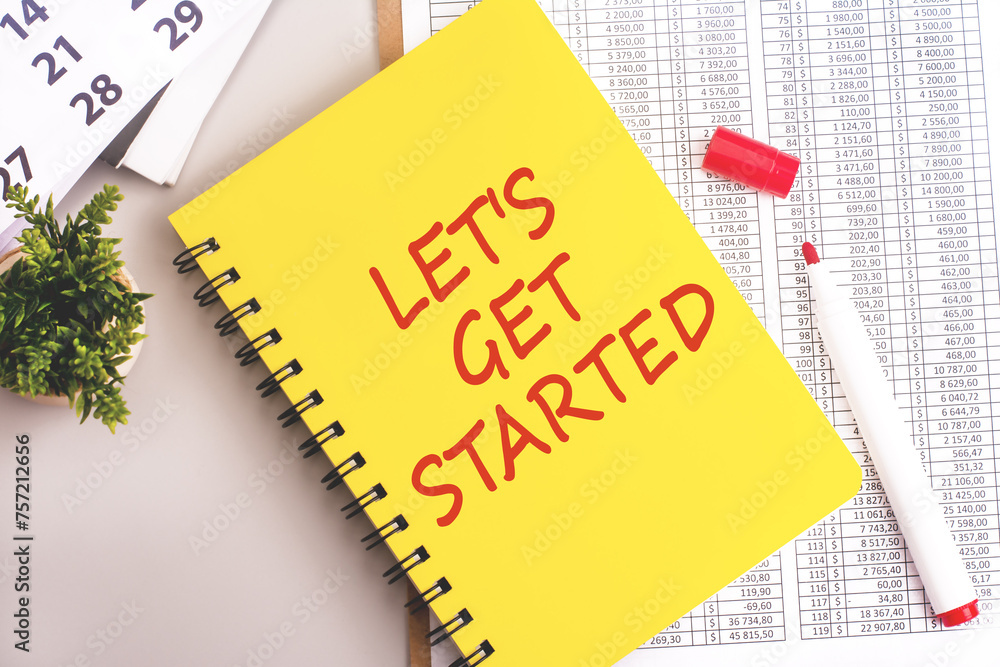 Poster the yellow notebook with 'let's get started' text on a grey background signifies a focus on growth m