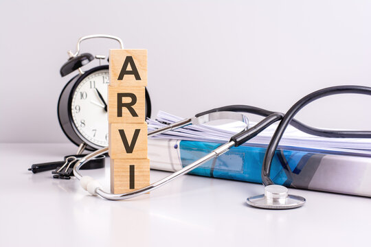 text ARVI is written on wooden cubes near a stethoscope on a paper background. medical concept. ARVI - short for Acute Respiratory Viral Infection