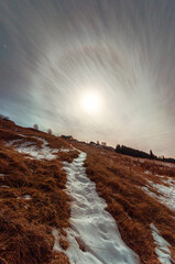 Moon halo clouds evening snow trail house