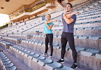 Fitness, arms and couple stretching at stadium for race, marathon or competition training for...