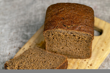dark square loaf of bread on the table