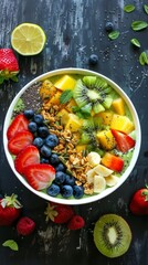 A bowl filled with various fruits such as apples, bananas, and grapes.