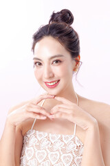 Beautiful young Asian woman model bun hair with natural makeup on face clean fresh skin on isolated...