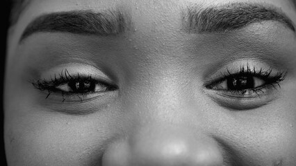 Intense stare of a black teen girl looking at camera in monochrome, black and white. Macro detail...