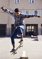 Man, skateboard and jump at urban skate park, sports and energy with skill, stunt and recreation...