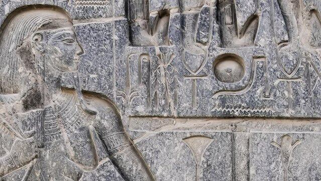 Egyptian hieroglyphs close-up in Luxor Temple, ancient Thebes, Egypt. Luxor Temple is a large Ancient Egyptian temple complex located on the east bank of the Nile River and was constructed 1400 BCE.