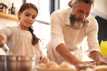 Girl, child and grandfather with baking in kitchen for cooking, cookies and teaching with support...