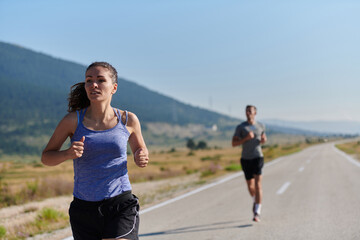 Energized by the beauty of nature, a couple powers through their morning run, their bodies and spirits invigorated.