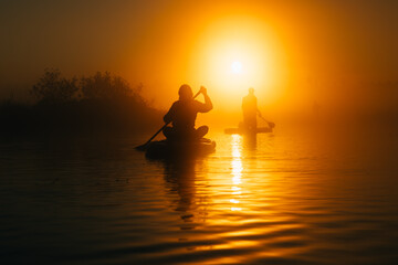 Silhouettes of a people paddling sup boards in sunrise - 757228806