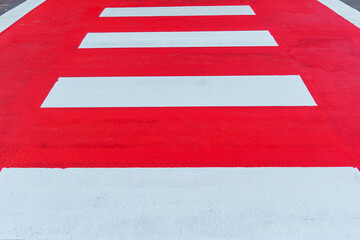 Red and white pedestrian crossing,Red and white crosswalk  on asphalt road