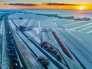 Winter sunrise over a frostcovered landscape with busy morning commute.
