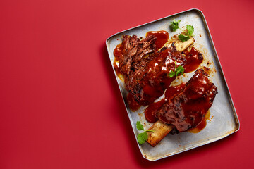 A delicious serving of barbecue ribs on a plate, ready to be enjoyed.