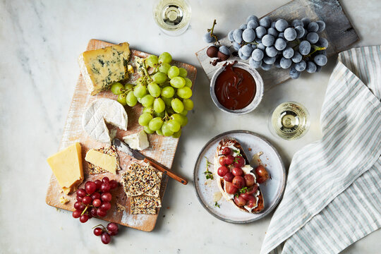 A gourmet cheese and fruit platter paired with wine on a leisurely afternoon.