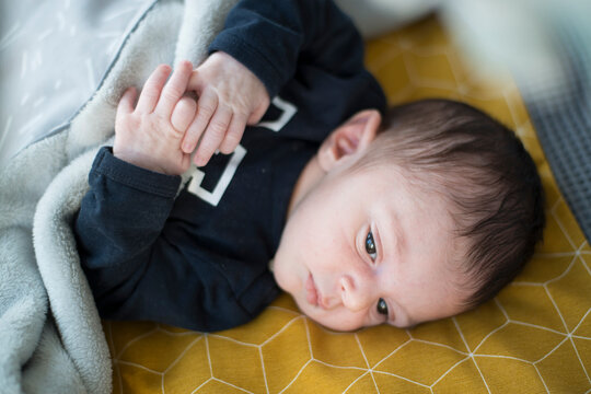 Tiny fingers grip tightly in a precious moment of connection