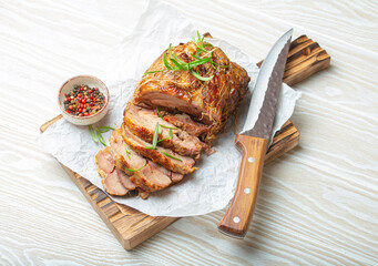 Rolled turkey roasted with spices and herbs on baking paper with knife and wooden white background top view. Baked cut for slices turkey fillet roll for dinner. - 757233439