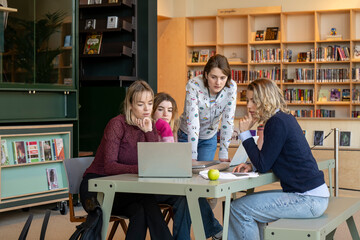 Group of students collaborating on a project in a library