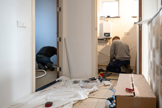 Two people busy with home renovation tasks.