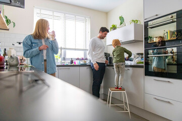 Family spending quality time in the kitchen cooking together.