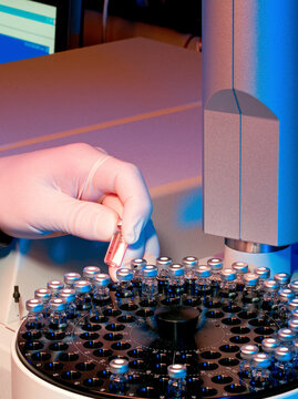 Scientist loading samples into an analytical machine