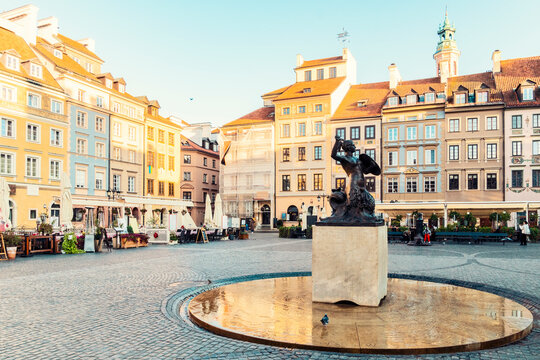 Famous Mermaid statue with historic colorful houses at Old Town Market Square, Warsaw, Poland