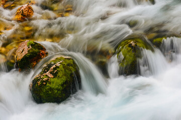 The wild cascades of the Velika Savica river in the heart of the Julian Alps in Slovenia above Lake...