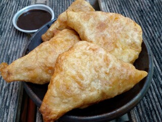 Martabak. The flour dough is filled with several mixed ingredients such as eggs, vermicelli, shallots and green onions. Martabak is served with petis or spices made from fermented fish or shrimp.