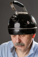 Sleepy man with closed eyes with a kettle on his head - 757242641