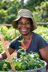 Close-Up Portrait Smiling Gardening Woman. Adult woman in sun hat smiling while gardening outdoors.