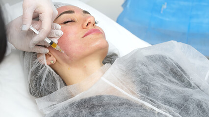 Medical cosmetology of plasma injections. Cosmetology, facial injections close-up. A professional...