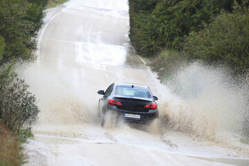 car driving on the road in the middle of the road.