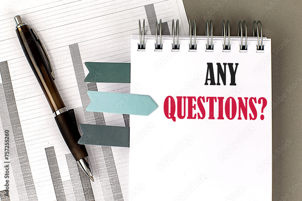 Poster any questions text on notebook with pen, calculator and chart on a grey background