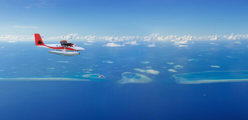 Seaplane flies over Maldives island