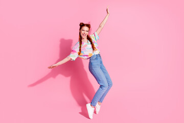 Full size photo of carefree eccentric funny girl dressed colorful blouse jeans standing on tiptoes...