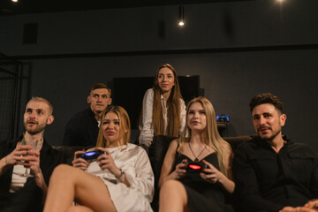 Women participate in video games during party with friends. Console adds interactive and enjoyable element to gathering with friends