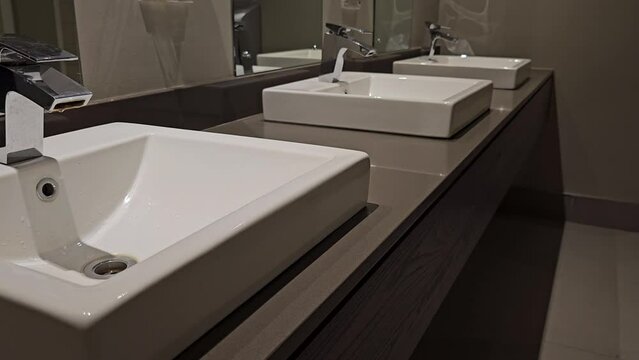 Modern sinks with mirror in public toilet concept