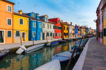 Fototapeta na wymiar February, 2016 Burano island with colorful houses and buildings on embankment of narrow water canal with fishing boats and view of Venetian Lagoon, Province of Venice, Veneto Region, Northern Italy. B