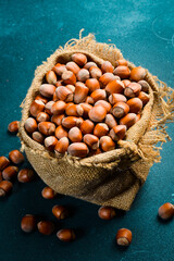 Hazelnuts in a fabric bag. Unpeeled hazelnuts in the shell. Organic healthy nuts. Close up.