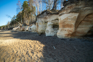 Eroded Sandstone Formations Amidst Tranquil Forest Landscape Under Clear Blue Sky. Veczemju cliffs,...