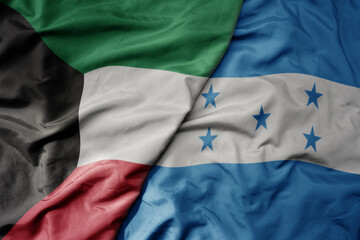 big waving national colorful flag of honduras and national flag of kuwait.