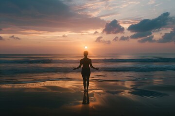 Silhouette meditation on the beach at sunrise