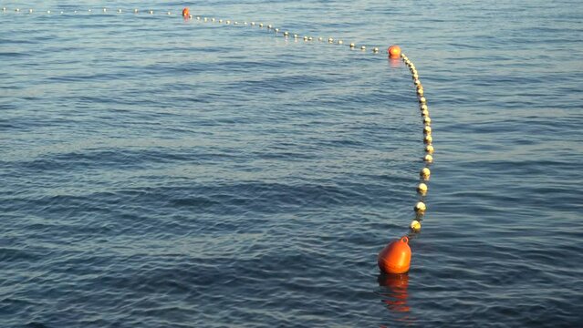 Floating fence of swimming area in sea