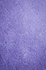 Violet textured surface, Venetian stucco for backgrounds. Top view.