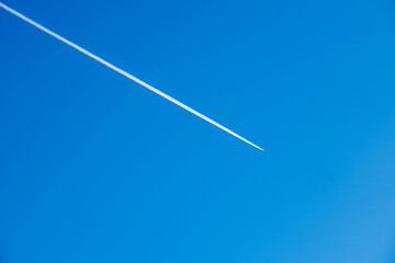 Clear Blue Sky Highlighted by Distinct Airplane Contrail.