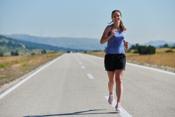 A determined woman athlete trains for success in the morning sun.