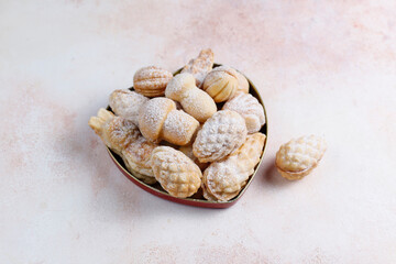 Homemade nut shaped russian soviet cookies and wafer rolls with pastry cream.