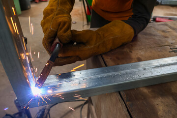 Galvanized metal after being welded with a welding machine caused a spark. Welder wearing...