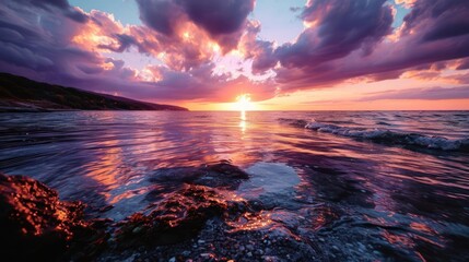 sunset over the sea, where the sky is adorned with shades of purple and orange, and the reflection...