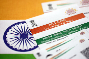 Indian Aadhaar card from Unique Identification Authority of India on Indian flag close up